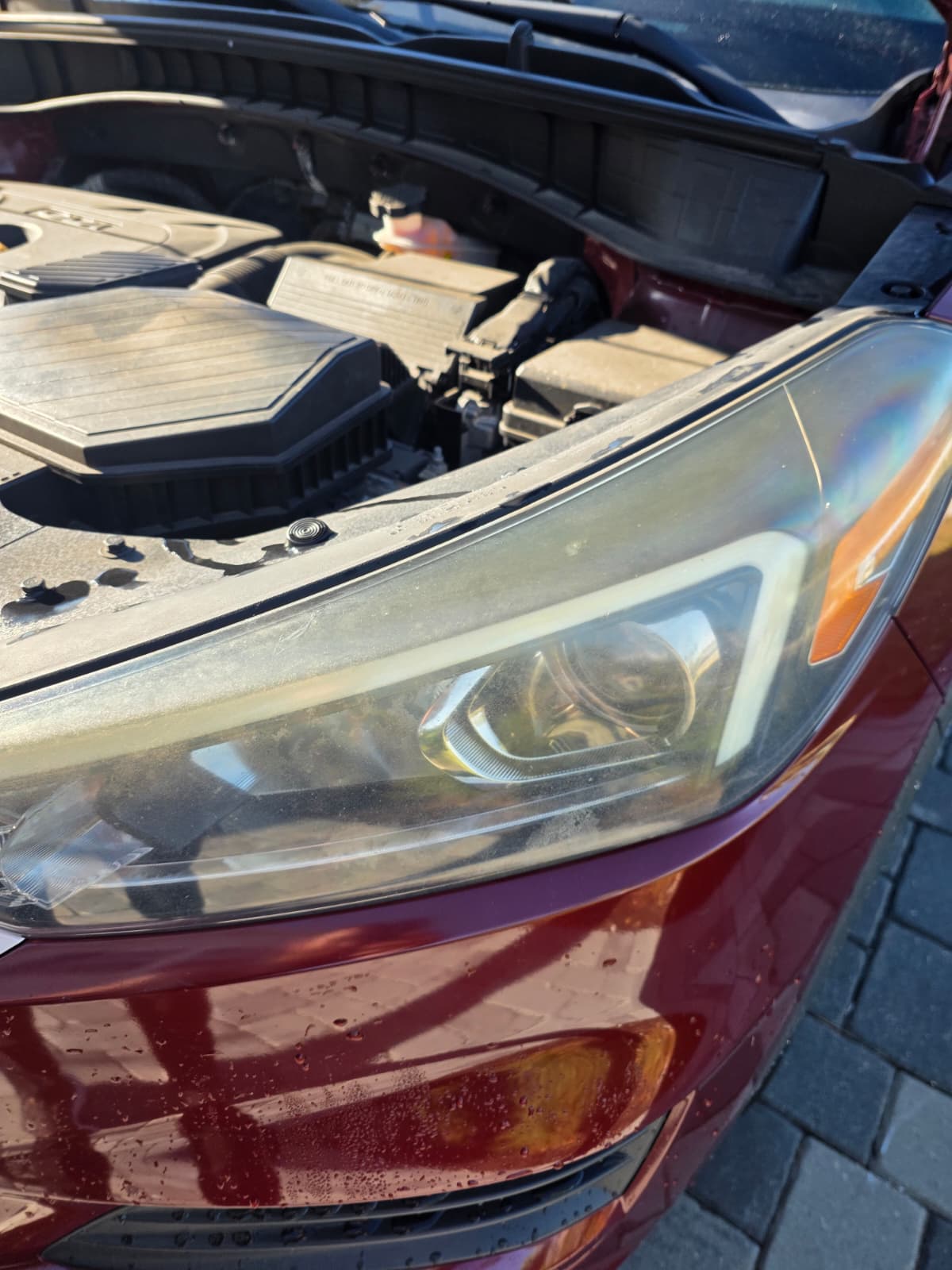 Headlight on a red vehicle — Before